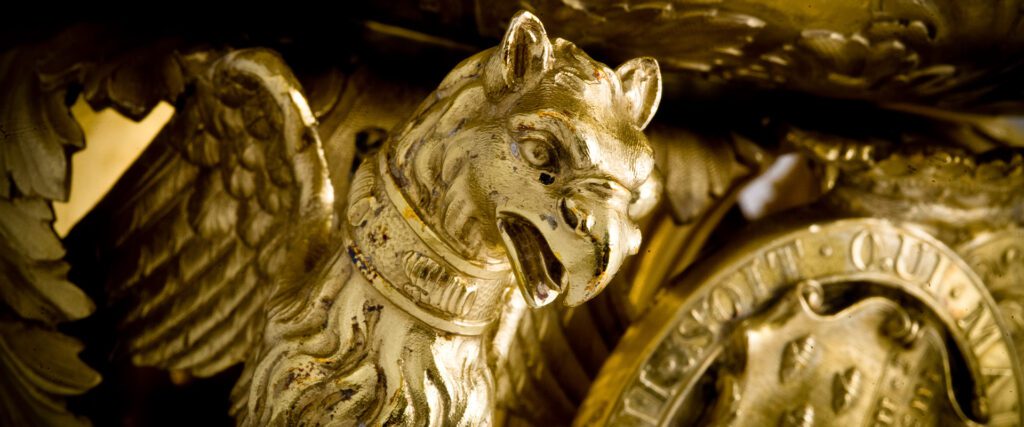 Extreme closeup of griffin perched on the side of a wine cooler made of silver-gilt, Robert Garrand, 1843