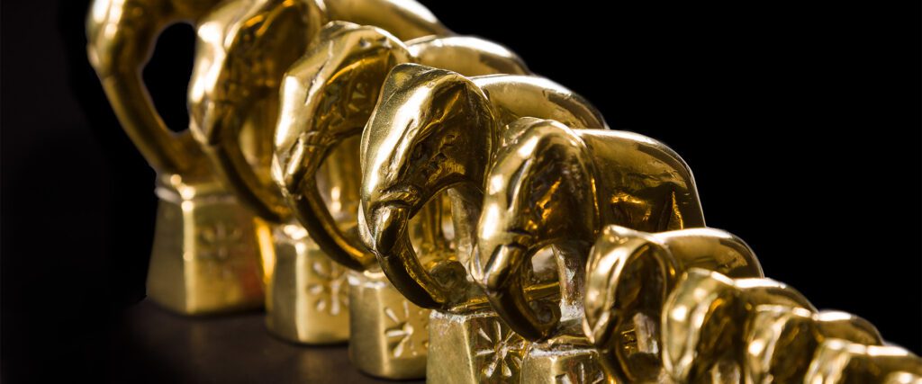 Closeup of graduated brass weights in the shape of elephants
