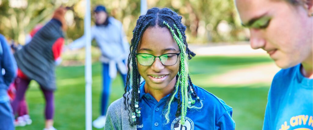 Close-up of high school-aged person at a discovery station in the Sunnylands gardens