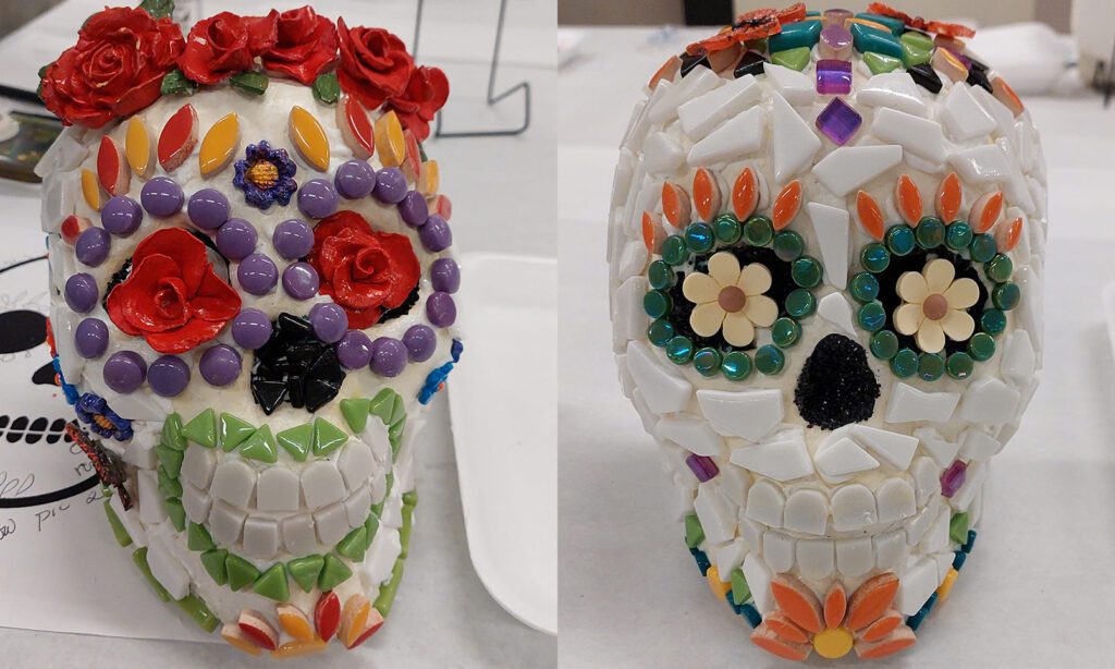 Two glass and mosaic skulls