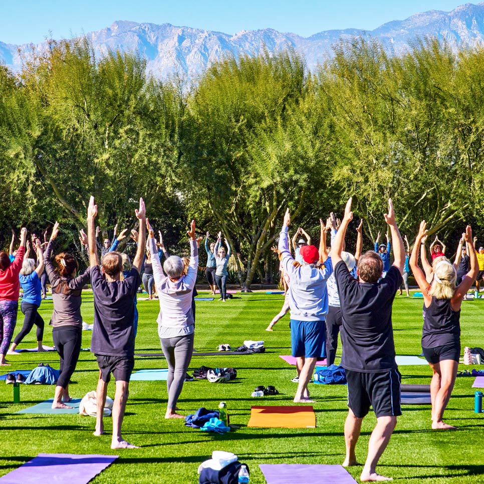Guests practicing yoga on the Great Lawn at Sunnylands