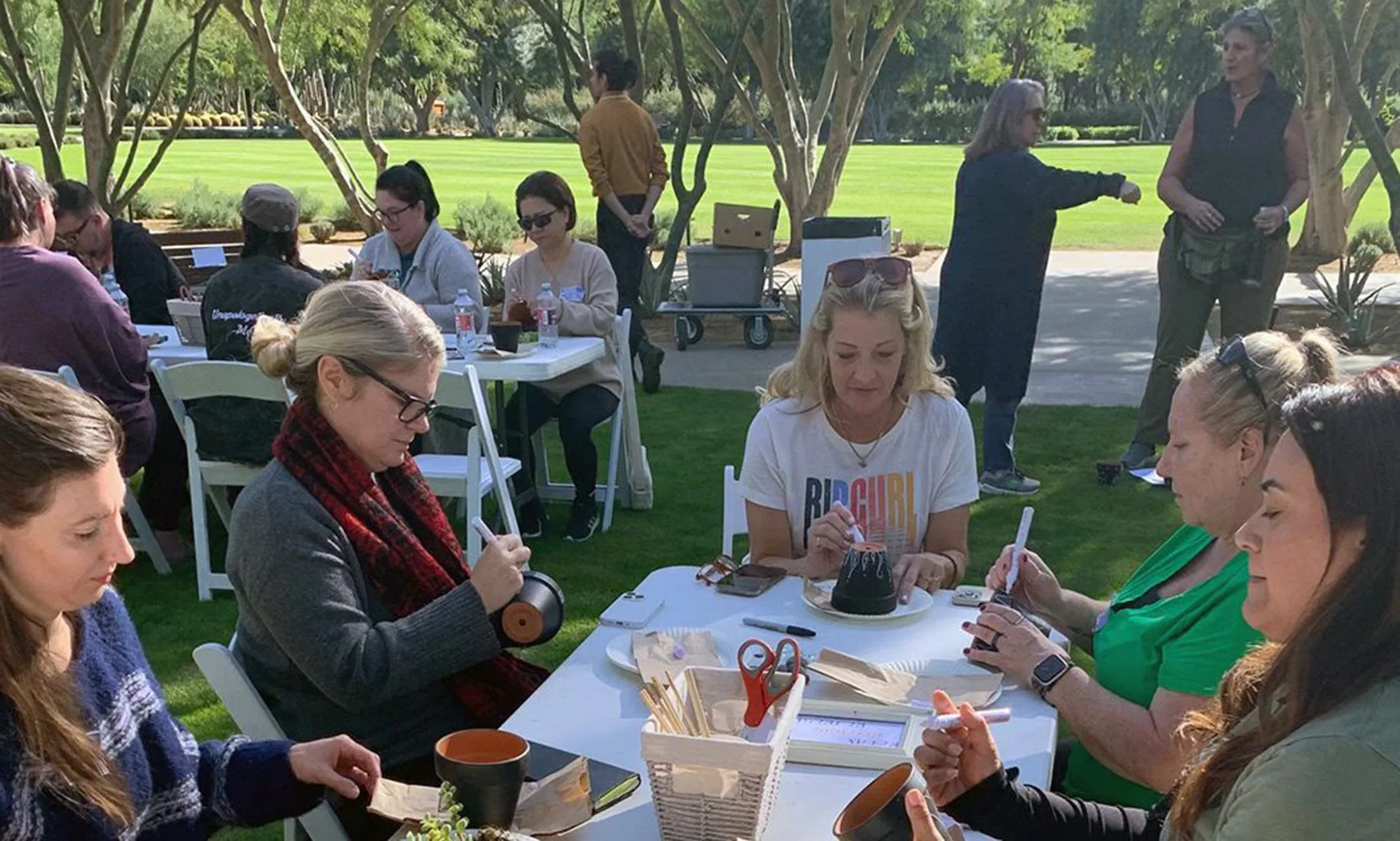 Workshop participants engage in a hands-on craft activity in the Sunnylands gardens